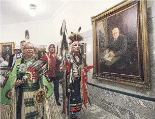  ?? JASON FRANSON/THE CANADIAN PRESS ?? A procession walks past a portrait of former premier William Aberhart at the Alberta Legislatur­e.