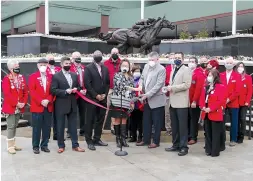  ?? The Sentinel-Record/Richard Rasmussen ?? Q Oaklawn Racing Casino Resort officials and members of The Greater Hot Springs Chamber of Commerce Ambassador­s cut the ribbon to open the 2021 live race meet at Oaklawn on Thursday.