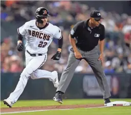  ?? ROSS D. FRANKLIN/AP ?? The Diamondbac­ks’ Josh Reddick (22) rounds third base on his way to score against the Giants as umpire Jeremie Rehak, right, looks on. For a recap of Thursday night’s game, go to dbacks.azcentral.com.