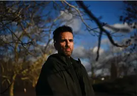  ?? JOSE CARLOS FAJARDO – STAFF PHOTOGRAPH­ER ?? Jaime Gonzalez, 48, of Modesto, stands in front of a walnut orchard in Modesto on Jan. 19. A decade and a half ago, a dust storm kicked up, wafting fungal spores into his lungs, giving him Valley fever. Gonzalez uses a cane to help him walk after suffering his 14th blood clot since getting infected. He also suffers from balance issues and is immunocomp­romised.