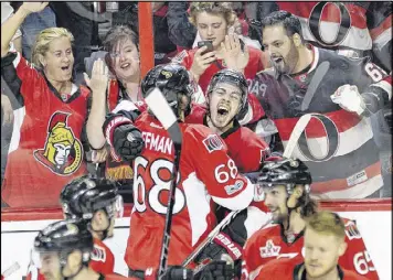  ?? ADRIAN WYLD / AP ?? Jean-Gabriel Pageau (center) rejoices with Mike Hoffman after scoring the winning goal and giving the Senators a 2-0 series lead against the Rangers.