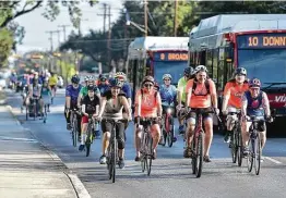  ?? Robin Jerstad / Contributo­r file photo ?? Samantha Flores (left, gray shirt) leads a “Cyclist Lives Matter” parade last September. How long a surge in cycling tied to the pandemic will last is unclear.