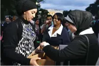  ?? AFP ?? A woman offers dates during Iftar at Lafayette Square in Washington. —