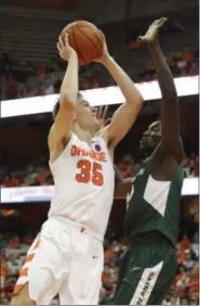  ?? NICK LISI - THE ASSOCIATED PRESS ?? Syracuse’s Buddy Boeheim, left, shoots against Le Moyne’s Souleymane Gueye during the first half of an NCAA college basketball game in Syracuse, N.Y., Wednesday, Oct. 31, 2018.