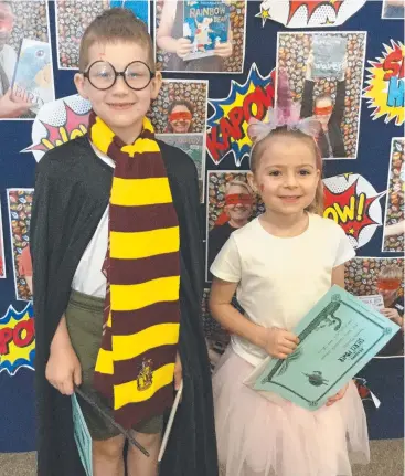  ?? Picture: LORRAINE GAMEAU ?? BEST COSTUMES: Jarvis Miller, Matilda Bradford holding their prizes in front of the library display.