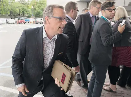  ?? ANDREW VAUGHAN/ The Canadian Press ?? Saskatchew­an Premier Brad Wall heads from a scrum with reporters at the summer meeting of Canada’s premiers in
St. John’s, N.L., on Thursday. Wall battled with Alberta Premier Rachel Notley over the Canadian Energy Strategy.