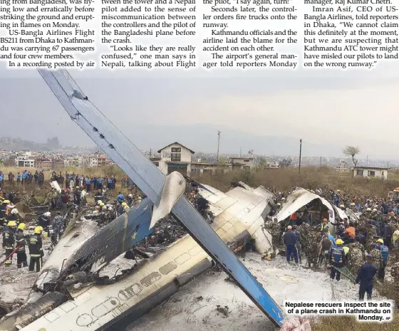  ?? AP ?? Nepalese rescuers inspect the site of a plane crash in Kathmandu on Monday.