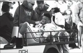  ?? ASSOCIATED PRESS ?? ALABAMA QUARTERBAC­K TUA TAGOVAILOA (13) is carted off the field after getting injured in the first half of Saturday’s game against Mississipp­i State in Starkville, Miss.