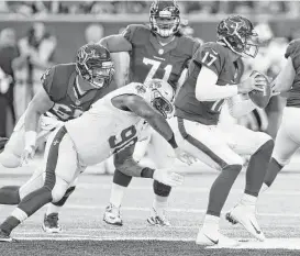  ?? Brett Coomer / Houston Chronicle ?? New Orleans defensive tackle Nick Fairley (90) beats Texans center Greg Mancz, left, and sacks Brock Osweiler in the first half Saturday. Mancz was thrust into his starting role when Nick Martin missed the game because of an ankle injury.