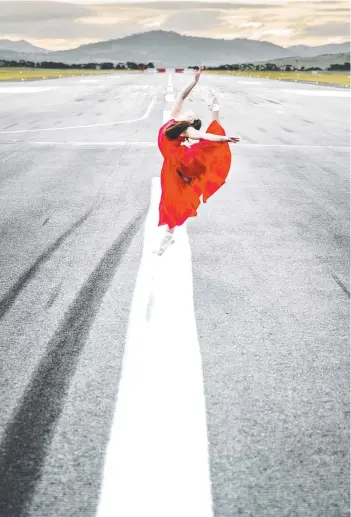  ??  ?? RARE SIGHT: Teenage ballet dancer Madison Heidenreic­h at Hobart Internatio­nal Airport while flights are minimal during the coronaviru­s pandemic.