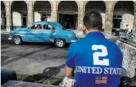  ?? YAMIL LAGE / AFP / Gett y Imag es ?? A man wears a T-shirt displaying an American flag on a street in Havana.