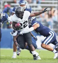  ?? Stew Milne / Associated Press ?? Purdue running back King Doerue (22) looks for yards against UConn on Saturday in East Hartford.