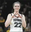  ?? AP file photo ?? Caitlin Clark of Iowa makes a heart gesture after a win over Michigan on Feb. 15.