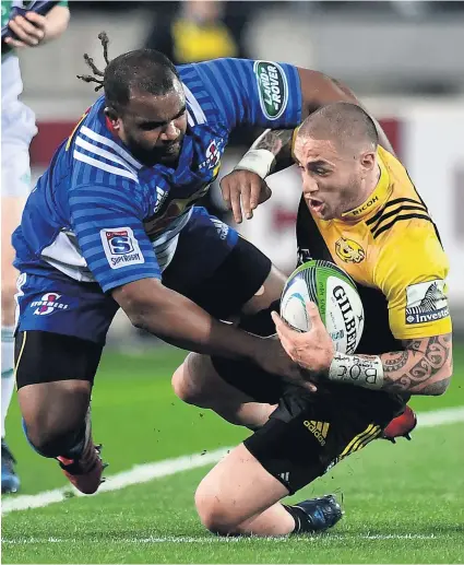  ?? Picture / Photosport ?? Hurricanes skipper TJ Perenara is tackled by Ali Vermaak during the Stormers’ loss in Wellington last night.