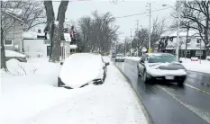  ?? JULIE JOCSAK/STANDARD STAFF ?? A car is snowed in on Lake Street in St. Catharines on Wednesday.