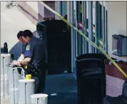  ?? MARY ALTAFFER — THE ASSOCIATED PRESS ?? Emergency service personnel work at the scene of a supermarke­t shooting Tuesday in West Hempstead, N.Y.