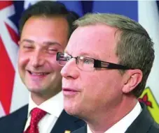  ?? ANDY CLARK/REUTERS ?? Saskatchew­an Premier Brad Wall, front, and P.E.I. Premier Robert Ghiz announce details of a joint drug-buying plan Friday in Ottawa.