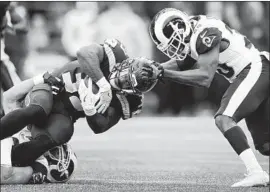  ?? Otto Greule Jr Getty Images ?? MIKE DAVIS is stopped by linebacker Connor Barwin, who was back in the lineup as the Rams held Seattle to less than half of their total yardage, 352 to 149.