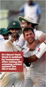  ??  ?? It’s there! Yasir Shah is mobbed by teammates after taking the winning wicket against the West Indies