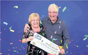  ?? SUPPLIED PHOTO ?? Sandra and Bob Donladson of Smithville celebrate their $ 23- million lottery win at the Ontario Lottery and Gaming prize office in Toronto.