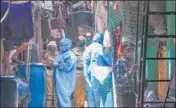  ?? PTI ?? Health workers wearing protective suits screen the residents of Naik Nagar during a house-to-house health survey in Mumbai.