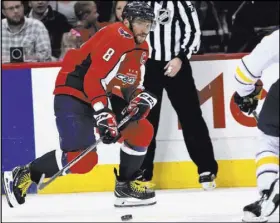  ?? Susan Walsh The Associated Press ?? Capitals left wing Alex Ovechkin takes the puck into the Buffalo zone against Sabres defenseman Casey Nelson in the third period of Washington’s 5-1 win Saturday at Capital One Arena.