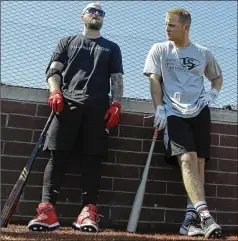  ?? DARRON CUMMINGS / ASSOCIATED PRESS ?? With the MLB sides at a standoff, the Cincinnati Reds’ Tucker Barnhart (left) and Josh VanMeter chat during a workout over the weekend at Grand Park in Westfield, Ind., with proceeds from the event going to Reviving Baseball in the Inner City of Indianapol­is.