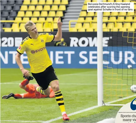  ??  ?? Borussia Dortmund’s Erling Haaland celebrates after scoring the opening goal against Schalke in front of no fans