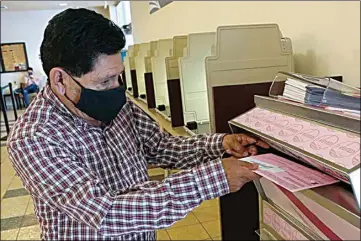  ?? RICH PEDRONCELL­I / AP ?? In this Aug. 30 file photo, Francisco Torres casts his ballot at the Sacramento County Registrar of Voters office in Sacramento.