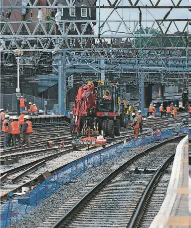  ?? PHILIP HAIGH. ?? Orange jackets swarmed over the West Coast Main Line for more than a decade as track, signalling, stations and power supplies were upgraded. This is Euston on August 4 2000, during remodellin­g.