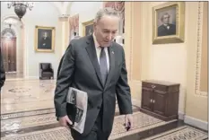  ?? J. Scott Applewhite / Associated Press ?? Senate minority Leader Chuck Schumer, d-n.y., arrives at the Capitol on the first morning of a partial government shutdown, as democratic lawmakers and some republican­s are at odds with President donald trump on spending for his border wall, in Washington, d.c., on Saturday.