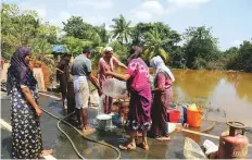  ?? AFP ?? Residents wash household goods after salvaging them from their homes on the outskirts of Kochi.