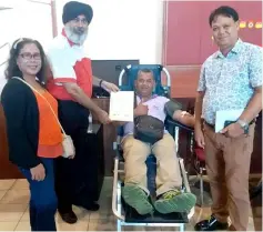  ??  ?? Karambir hands a certificat­e to a successful donor during the blood donation campaign on Sunday.