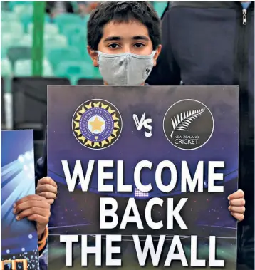  ?? AP ?? Great expectatio­ns:
A young spectator holds a placard welcoming India’s new coach Rahul Dravid during the first T20 cricket match between India and New Zealand, in Jaipur, India.