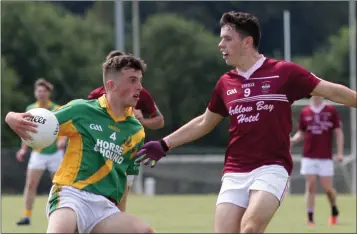  ??  ?? Paddy Murphy of Rathgarogu­e-Cushinstow­n giving Oisín Condren (Castletown) the slip in their JFC Group A game in Hollymount on Sunday. The New Ross District side won by a goal.