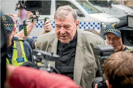  ?? NINE ?? Cardinal George Pell makes his way into a Melbourne court. He’ll leave in custody when he appears tomorrow.