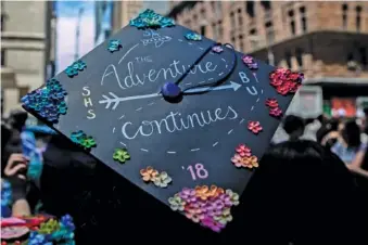  ?? JEENAH MOON/THE NEW YORK TIMES ?? A student wears a decorated cap outside a 2018 graduation ceremony at Carnegie Hall in Manhattan.