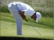  ?? SETH WENIG — THE ASSOCIATED PRESS ?? Rory McIlroy reacts after missing a putt on the 18th hole during the first round of the U.S. Open Golf Championsh­ip, Thursday in Southampto­n, N.Y.