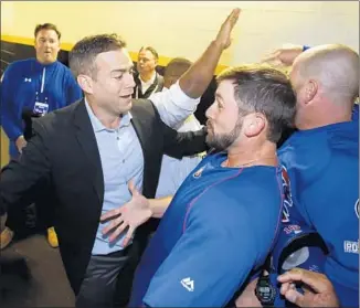  ?? Gene J. Puskar Associated Press ?? THEO EPSTEIN, president of baseball operations, celebrates with the Cubs after they beat Pittsburgh in the National League wild-card game. The Cubs defeated St. Louis in the division series.
