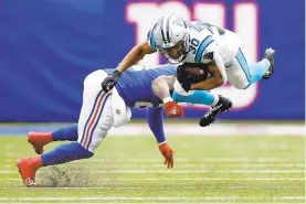  ?? SARAH STIER/GETTY ?? The Carolina Panthers’ Chuba Hubbard is tackled by the New York Giants’ Jabrill Peppers during the second half of Sunday’s game at MetLife Stadium in East Rutherford, New Jersey.