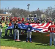  ?? DEBBBY HIGH — FOR DIGITAL FIRST MEDIA ?? The Intermedia­te team held the banner of the flag on the field during the signing of the National Anthem at North Penn Little League Opening Day Celebratio­n on Saturday.