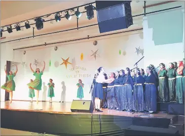  ??  ?? The school’s choir (right) and band (left) accompany ballet dancers in a performanc­e.