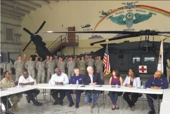 ?? Ken Thomas / Associated Press ?? Vice President Mike Pence (center) discusses hurricane recovery efforts at a briefing with local officials at Henry Rohlsen Airport on the island of St. Croix in the U.S. Virgin Islands.