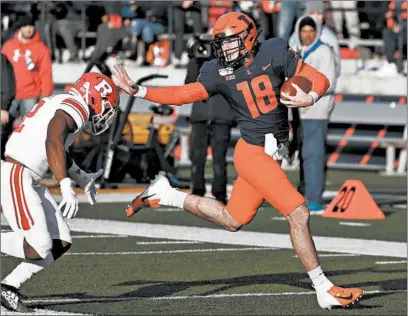  ?? CHARLES REX ARBOGAST/AP ?? Illinois quarterbac­k Brandon Peters runs for 54 yards as Rutgers defensive back Christian Izien chases during the second half Saturday.