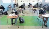  ??  ?? FIRST LESSONS: Grade 7 pupils of East London High School get their heads down and into their books on the first day of the reopening of schools since lockdown.