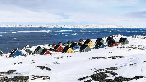  ??  ?? Characteri­stic colorful wooden houses in a suburb of Greenland’s capital city, Nuuk, near the southern tip of the country.