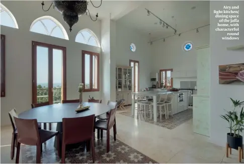  ??  ?? Airy and light kitchen/ dining space of the Jaffa home, with characterf­ul round windows