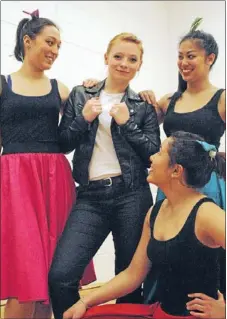  ??  ?? Rocking hip-hop: Rinaha Bridge-Comer, Kirsten Ocampo and Esther Lau Young, on ground, eye up Anna Robinson, who plays Danny in Infinite’s production of Grease.