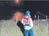  ??  ?? Rescuers go over cliff to reach angler