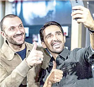  ??  ?? IVAN BASSO (left) and Alberto Contador take a selfie at a ceremony welcoming Gruppo Uvet to Contador’s Foundation.